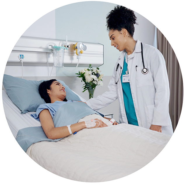 Women, doctor and patient in bed with smile at hospital for checkup, good news and feedback. People, happy and satisfied with recovery on illness or disease with care, support and love or trust.